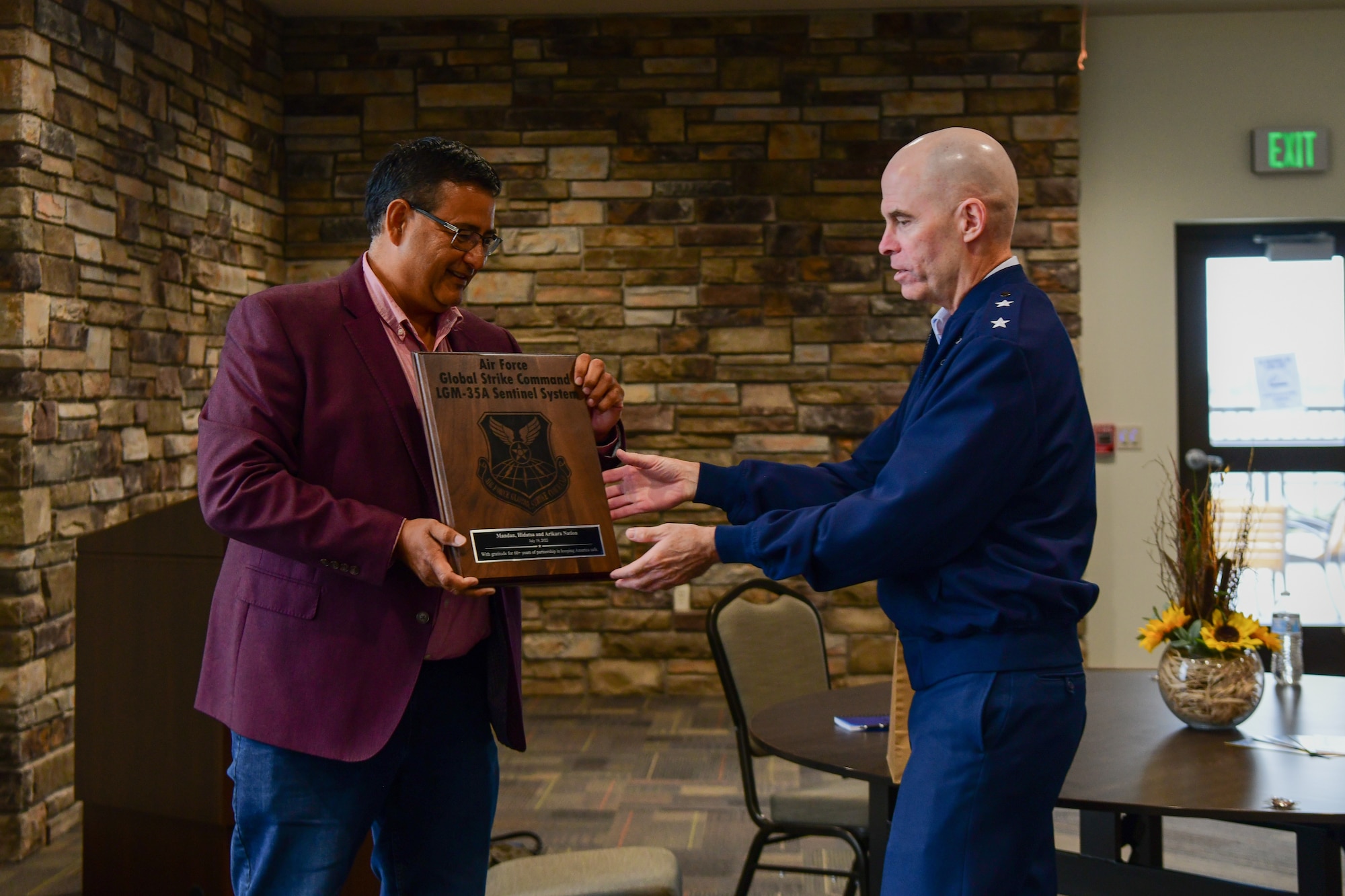 Maj Gen. Michael Lutton, Twentieth Air Force commander and Three Affiliated Tribes Chairman Mark Fox exchange gifts at Fort Berthold Reservation New Town, N.D. July 19, 2022.