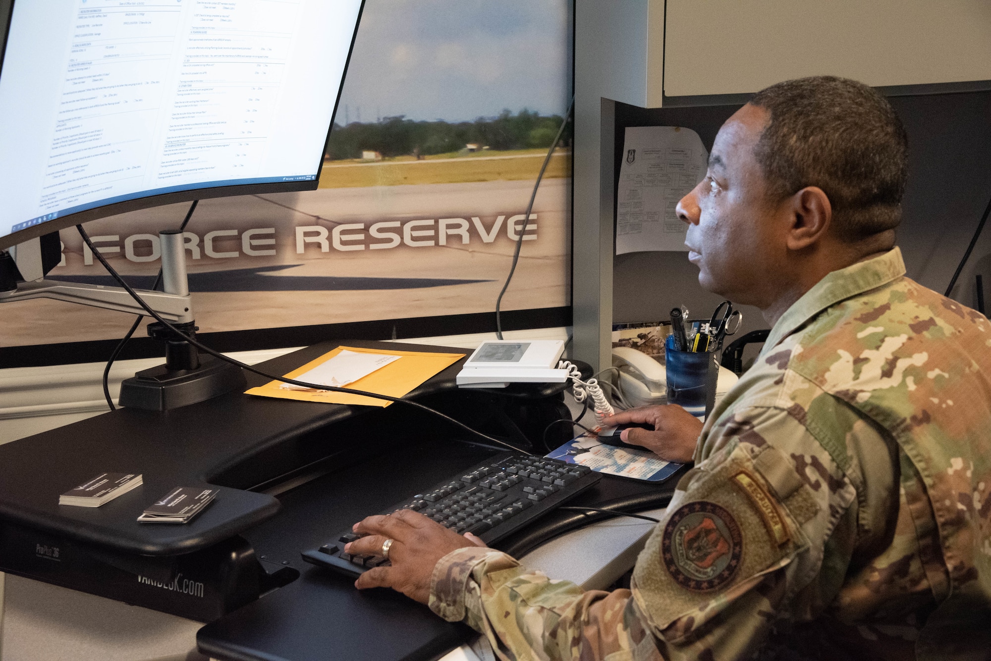 Shearin sits at his desk and works on his computer