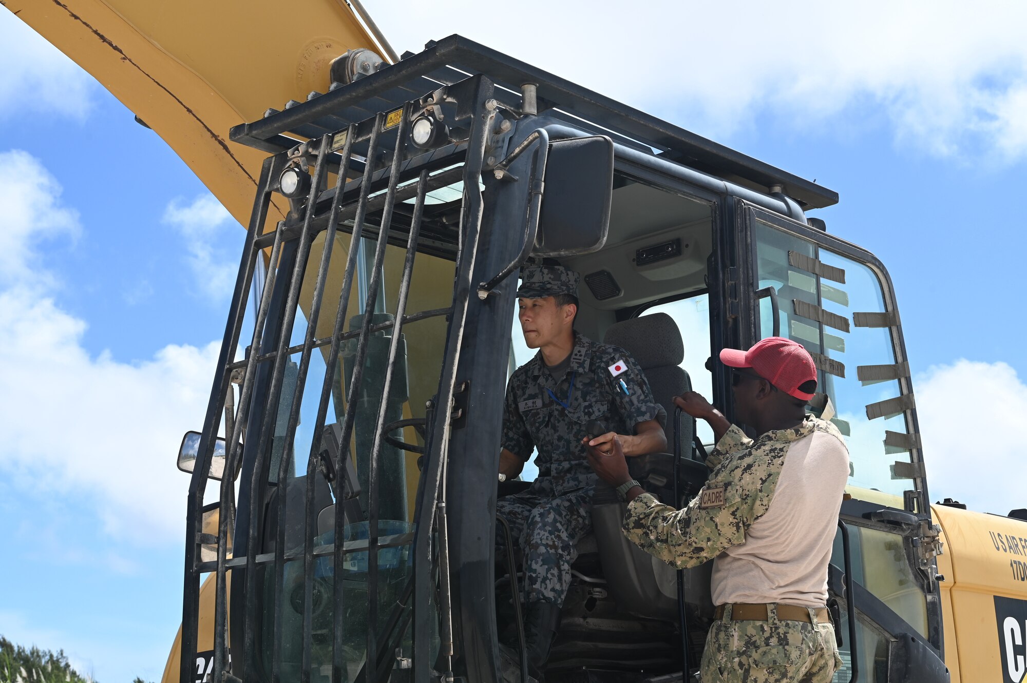 U.S. Navy and Japan Air Self-Defense Force Airmen operate heavy machinery during Silver Flag at Northwest Field, Guam, June 30, 2022.