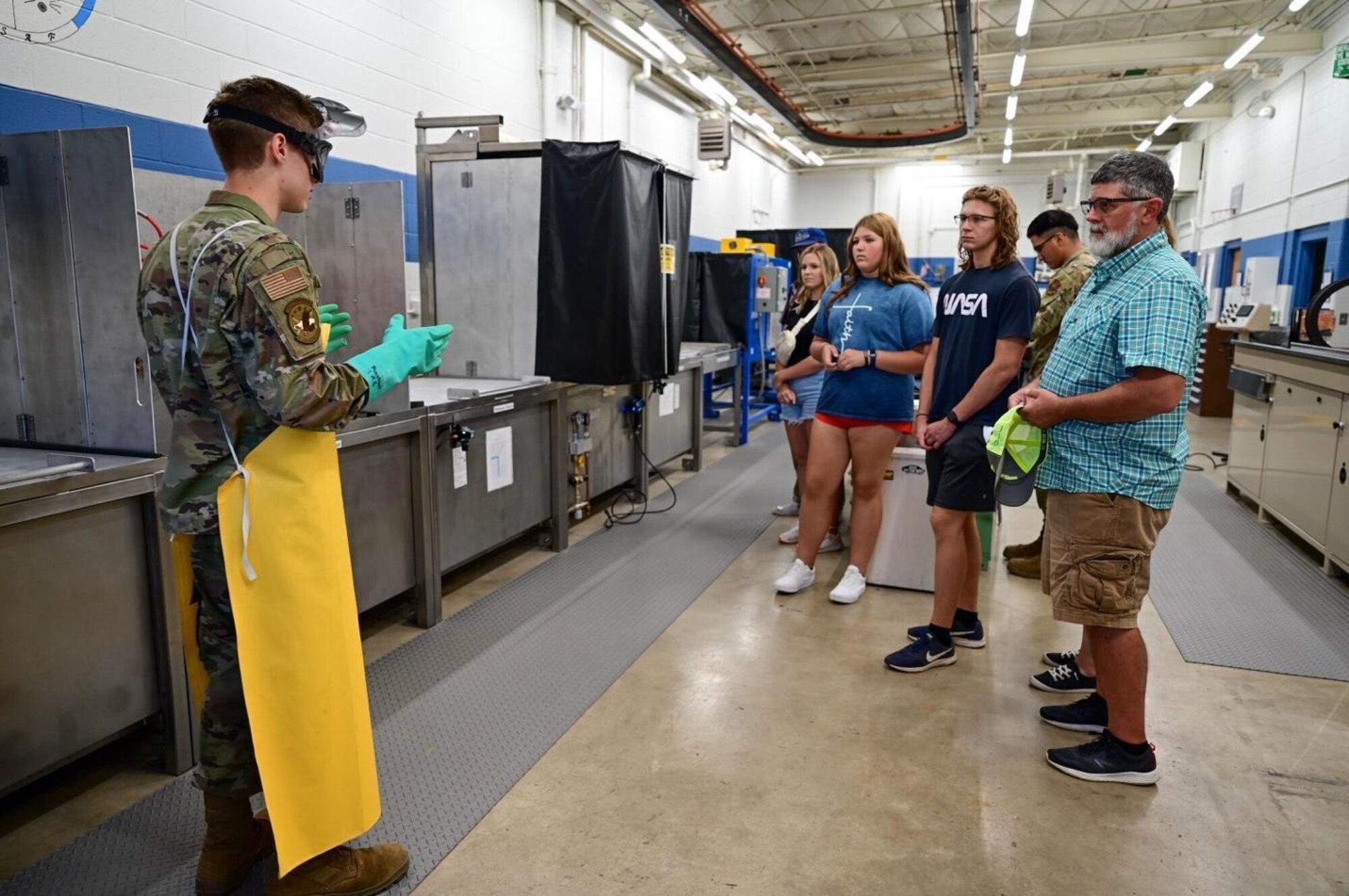 Airman 1st Class Brett Miska, a 28th Maintenance Squadron Fabrication Flight non-destructive inspection apprentice, provides a demonstration of the Fluorescent Penetrant Line within the NDI lab at Ellsworth Air Force Base, S.D., July 13, 2022.