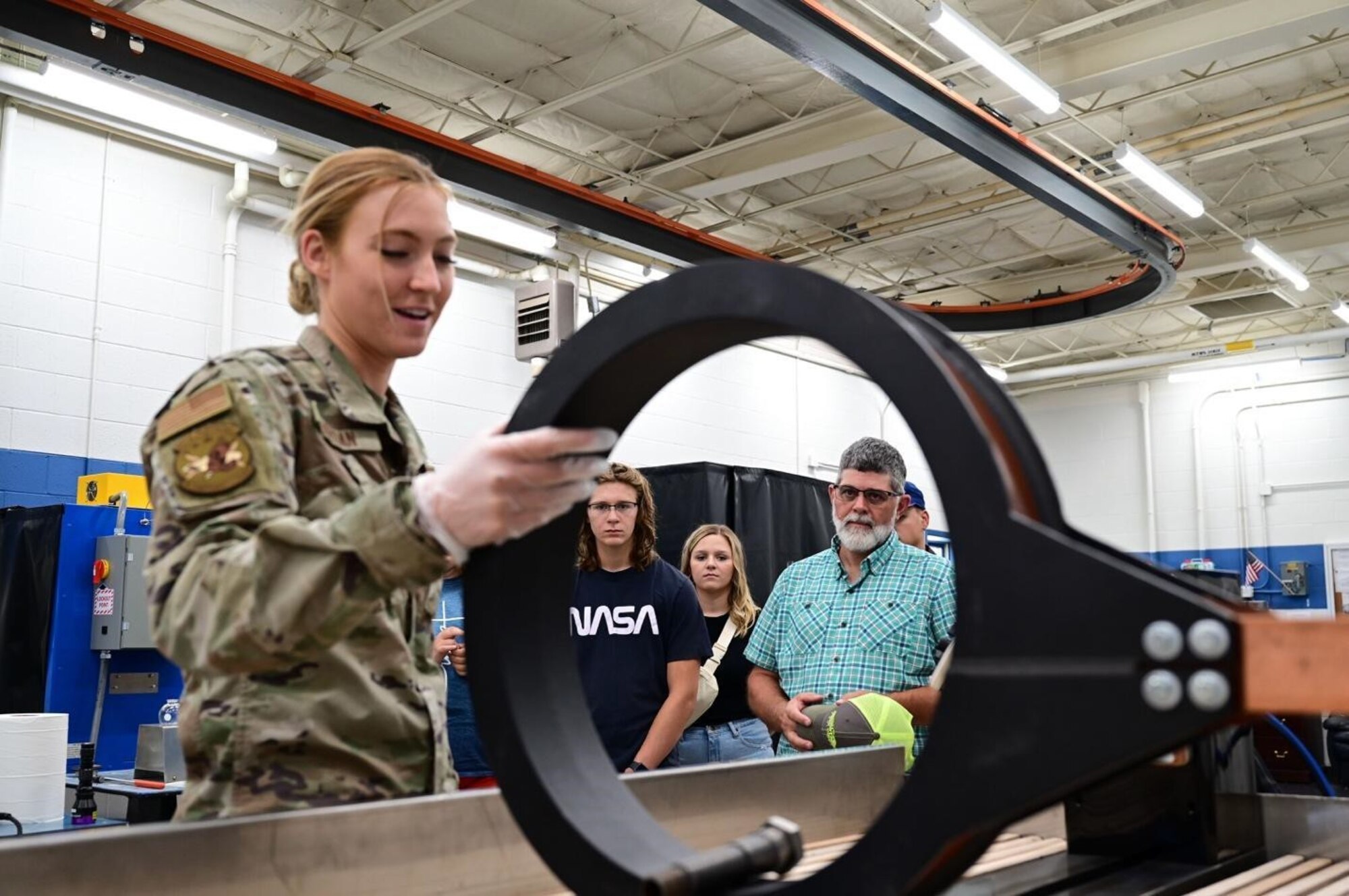Marvin Pepper and his family are given a tour of the Non-Destructive Inspection laboratory by Senior Airman Faith Jordan, an 28th Maintenance Squadron Fabrication Flight NDI technician, at Ellsworth Air Force Base, S.D., July 13, 2022.