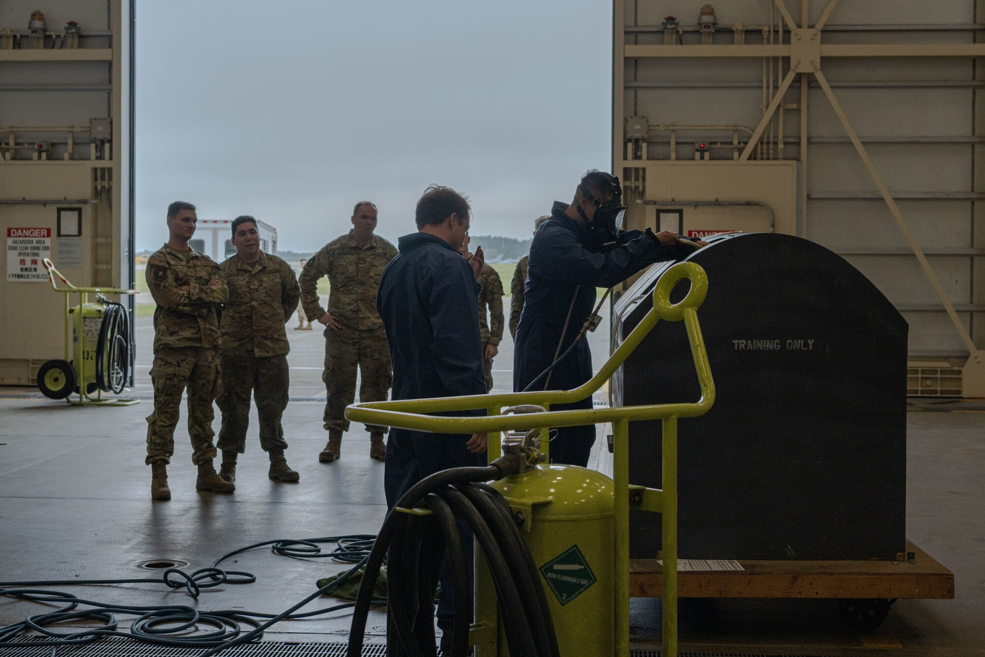 People in uniform work on an aircraft