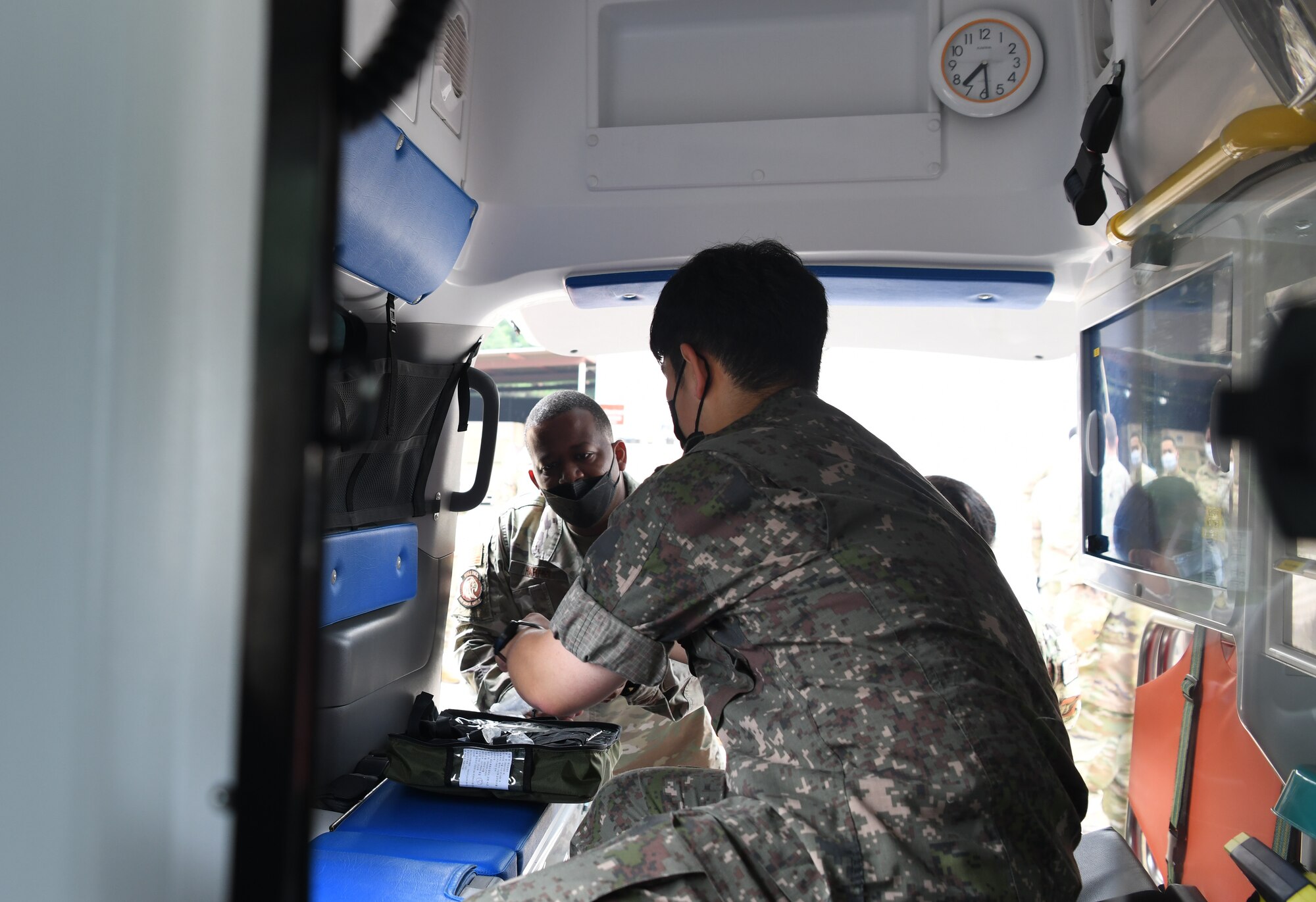 U.S. Air Force Maj. Eugene Harris, left, 8th Medical Group chief of education and infection prevention, looks at Republic of Korea Tech. Sgt. Mo Seh Yang’s, ROKAF Medical Group emergency medical technician, ambulance equipment at Kunsan Air Base, Republic of Korea, July 19, 2022. Immersion trainings provide opportunities for U.S. and ROKAF members to work interoperability and enhance future mission fluidity. (U.S. Air Force photo by Staff Sgt. Sadie Colbert)