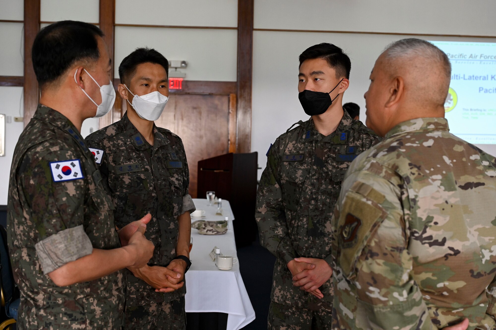 Members from the Republic of South Korea Air Force and U.S. Air Force converse during the Pacific Unity Multi-Lateral Civil Engineer Key Leader Engagement, June 22, 2022 at Andersen Air Force Base, Guam. Themes during this KLE included topics of shared interest across the allies and partners such as joint capabilities, leveraging expertise in the Total Force, and increased frequency of subject matter expert exchanges and multi-lateral training. (U.S. Air Force Photo by Airman 1st Class Emily Saxton)
