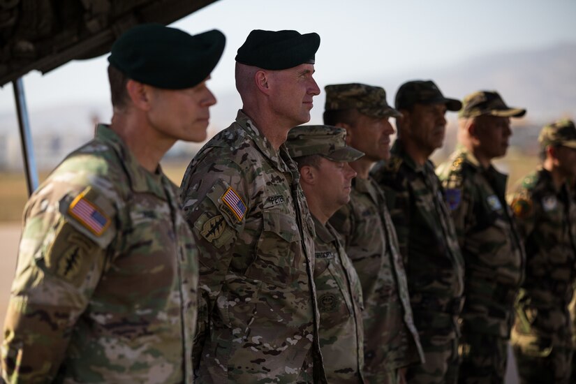 Soldiers stand in a formation.