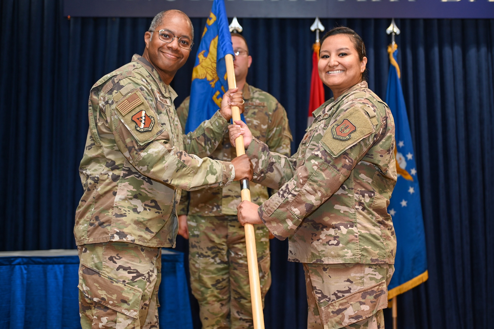 Maj. Claudia Santos (right), incoming 39th Force Support Squadron commander, receives the guidon from Col. Christopher Robinson, 39th Mission Support Group commander, during a change of command ceremony at Incirlik Air Base, Turkey, July 15, 2022.