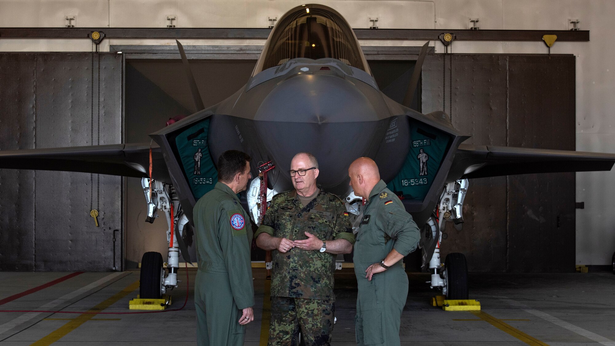 German Gen. Eberhard Zorn, Chief of Defense (center) speaks with U.S. Air Force Lt. Gen. Michael Loh, director, Air National Guard (left) and Lt. Gen. Ingo Gerhartz, chief of the German air force, in front of an F-35A Lightning II fifth generation fighter aircraft assigned to the 315th Fighter Squadron at Spangdahlem Air Base, Germany, July 19, 2022. As Germany's highest-ranking soldier, the Chief of Defense is responsible for the overall military defense concept and he has full command of the armed forces. The 52nd FW works regularly with their NATO partners to strengthen bonds, secure common interests and promote shared values.  (U.S. Air Force photo by Tech. Sgt. Anthony Plyler.)