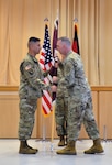 U.S. Army Col. Andrew Landers, commander, Landstuhl Regional Medical Center (LRMC), hands the command guidon to U.S. Army Command Sgt. Maj. Omar Mascarenas, during an Assumption of Responsibility Ceremony at LRMC, June 16.