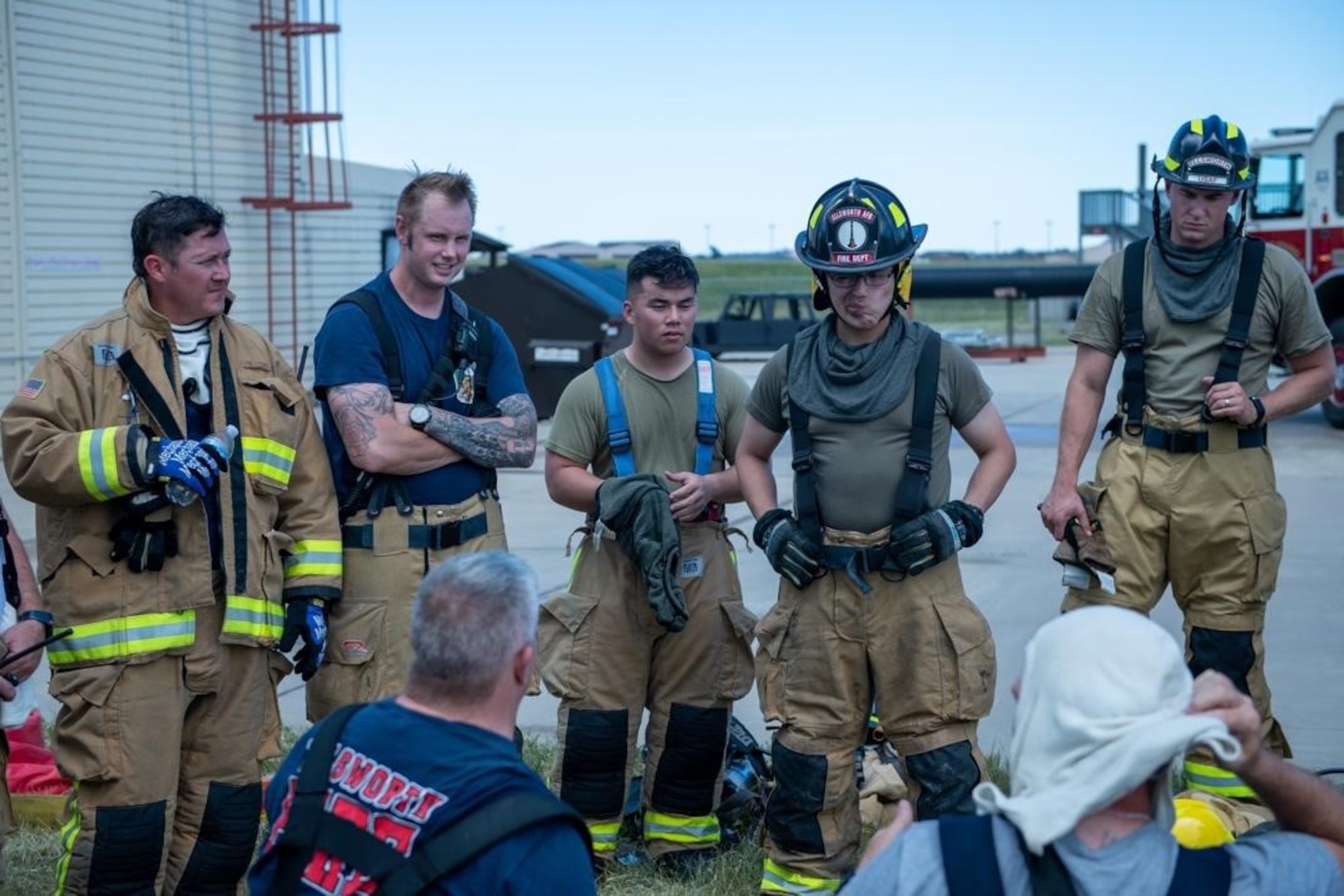 The 28th Civil Engineering Squadron Fire Fighting Unit discuss exercise performance on Ellsworth Air Force Base, S.D., July 13, 2022.