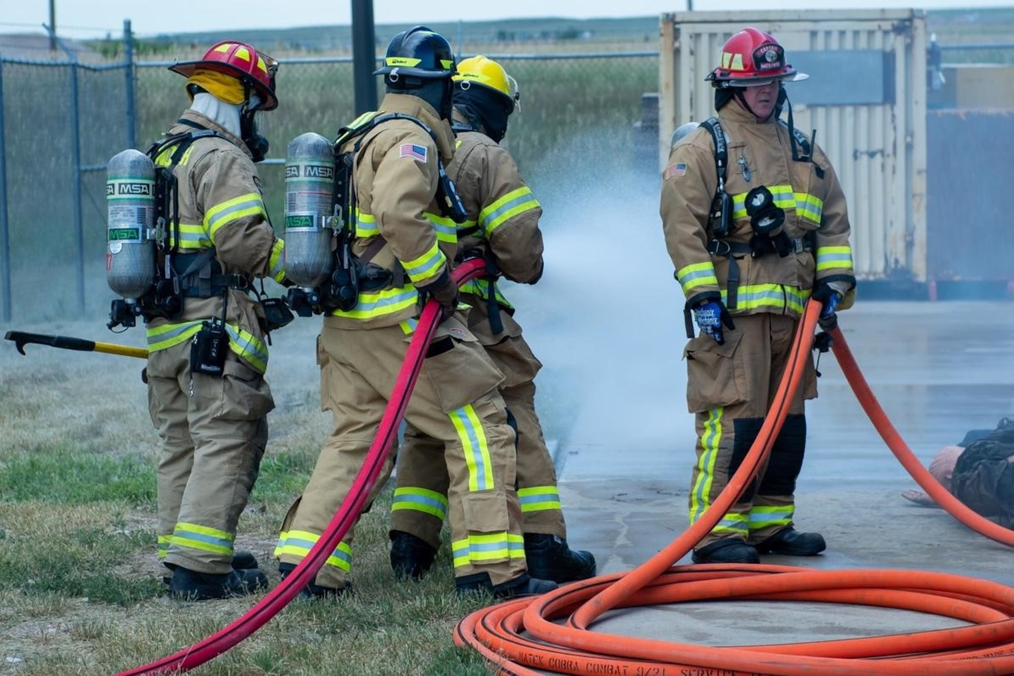 Personnel with the 28th Civil Engineering Squadron Fire Fighting Unit use a firehose on Ellsworth Air Force Base, S.D., July 13, 2022.