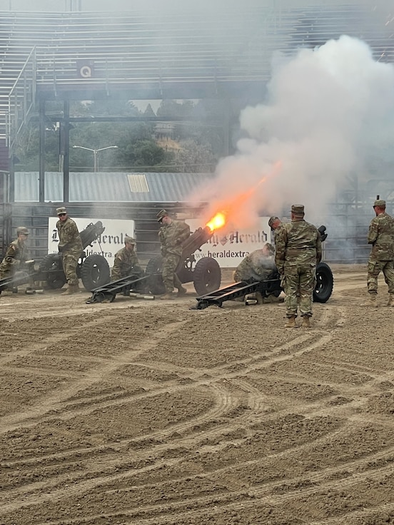 Soldiers fire a cannon salute.