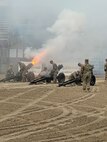 Soldiers fire a cannon salute.