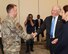 Secretary of the Air Force Frank Kendall and Gov. Gretchen Whitmer present a challenge coin and recognition to Master Sgt. Jason Bialy, 127th Operations Support Squadron, based here, July 8, 2022. An intelligence specialist, Bialy recently deployed in support of Joint Task Force Liberty, providing relocation support for more than 15,000 Afghan refugees. (U.S. Air National Guard photo by Terry Atwell)