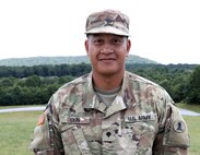 Spc. Ronald Oun, an electrical engineer assigned to the 160th Engineer Company, 721st Troop Command, 72nd Troop Command, Delaware Army National Guard poses for a photo during training at the combined arms collective training facility at Fort Indiantown Gap, Pa. July 14, 2022. (U.S. Army National Guard photo by Pfc. Aliyah Vivier)