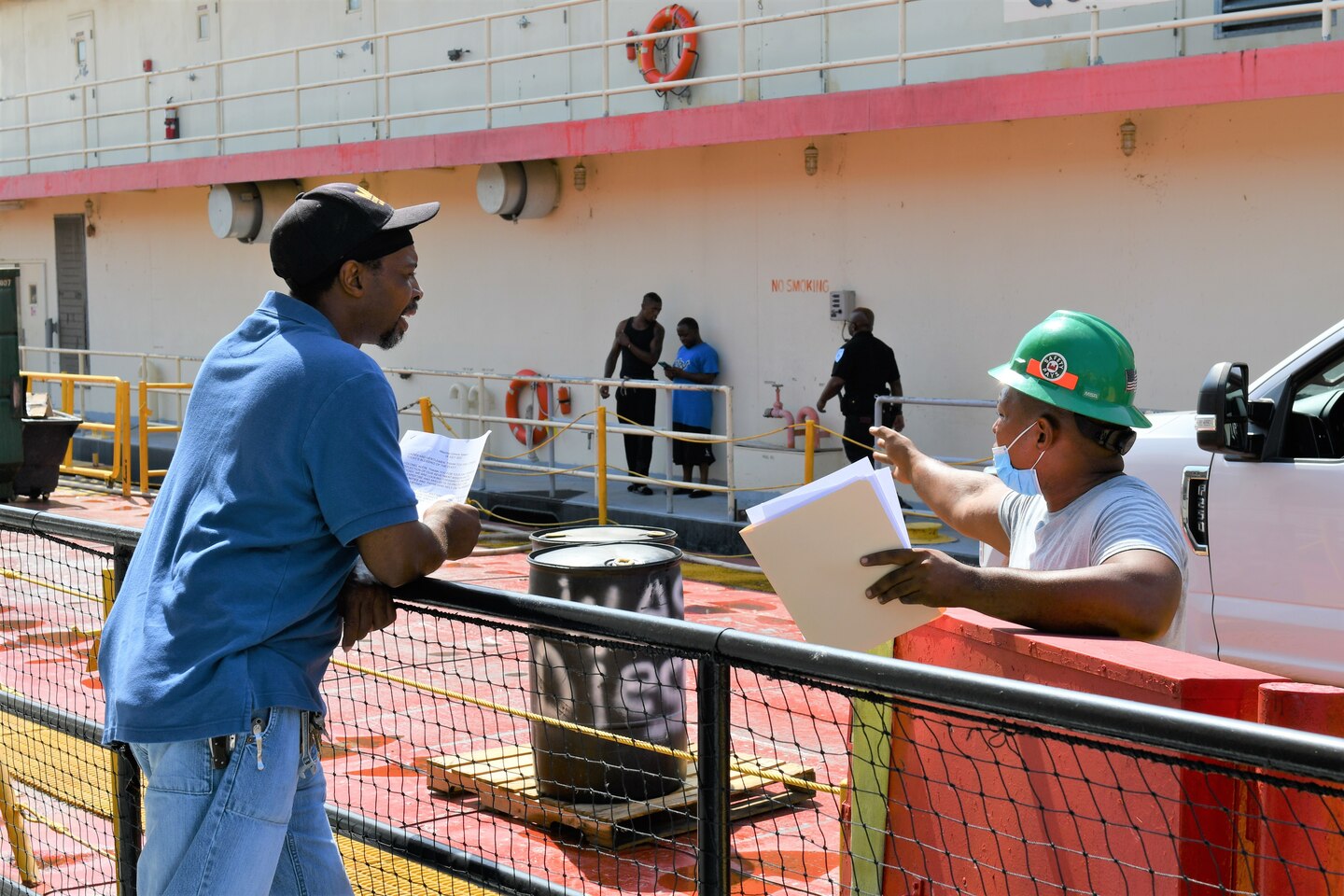 Mat Sinking Unit Chief Maurice Gilmore talks with crew member.