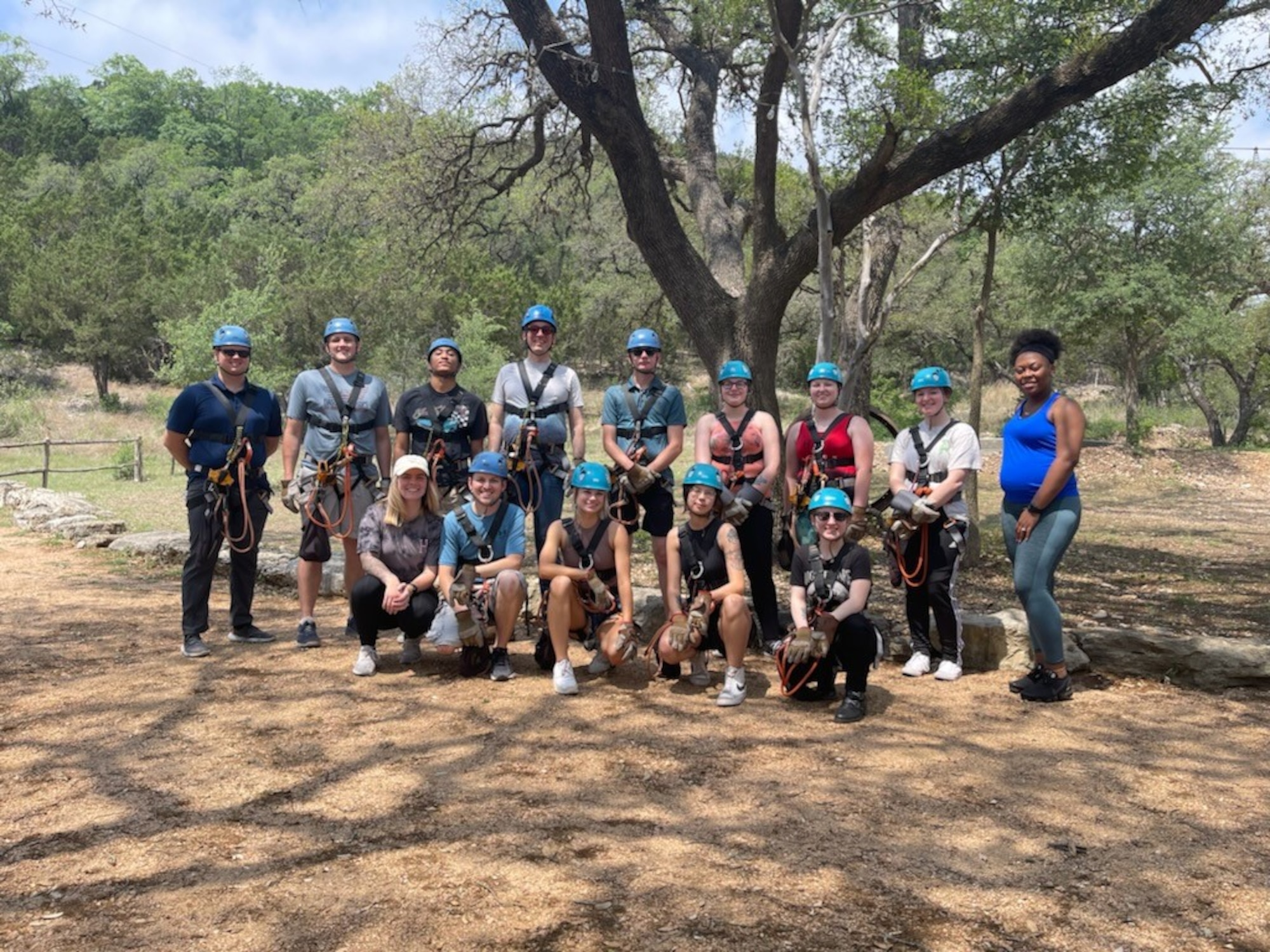 Group photo of people in helmets and safety straps.