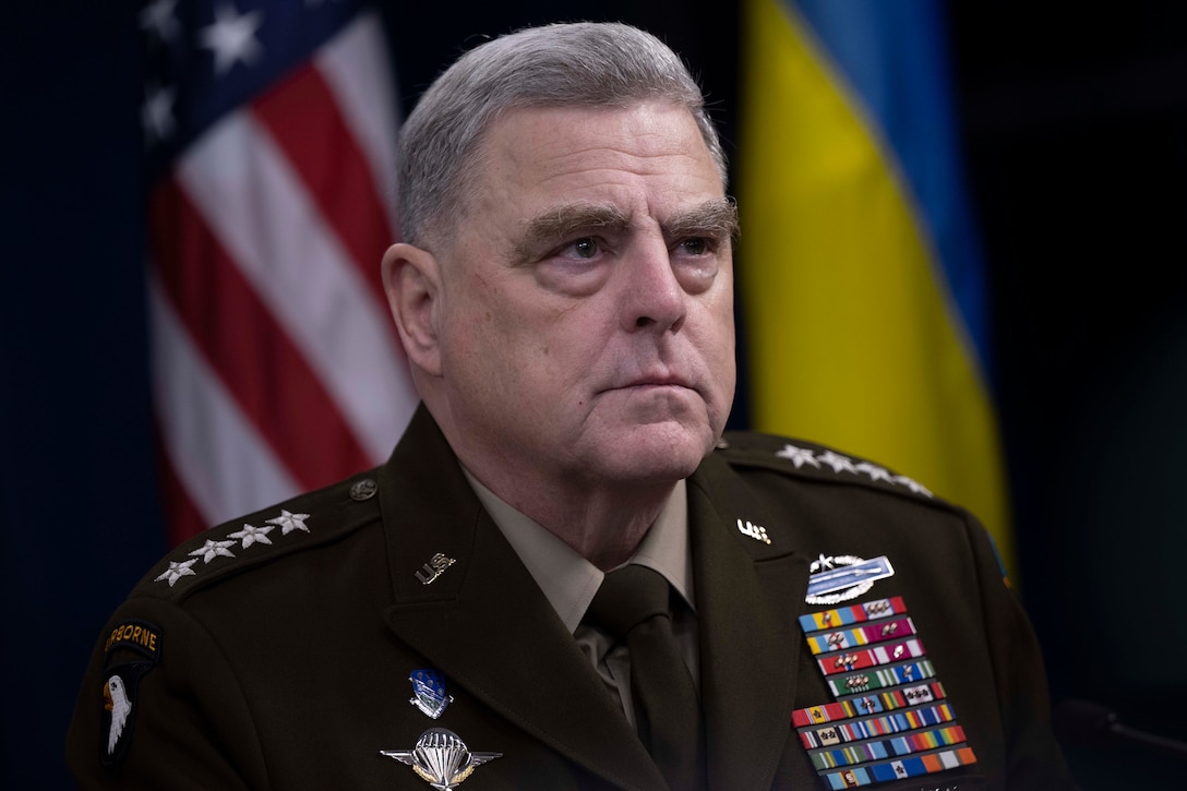 Army Gen. Mark A. Milley, chairman of the Joint Chiefs of Staff, with two flags in the background.