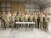 Deployed Soldiers assigned to the 1067th Composite Truck Company stand with service members of allied nations during their multi-day training event. The purpose of the training was to foster partnership with coalition forces and included weapon system familiarization, medical aid, rollover training and presentations from coalition service members. The coalition service members even shared the kind of food that comes in their meals ready to eat (MREs). (U.S. Army photo by 1st Lt. Michael Demboski)