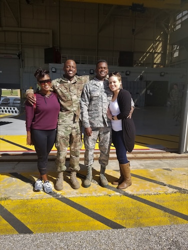 four people pose for a photo