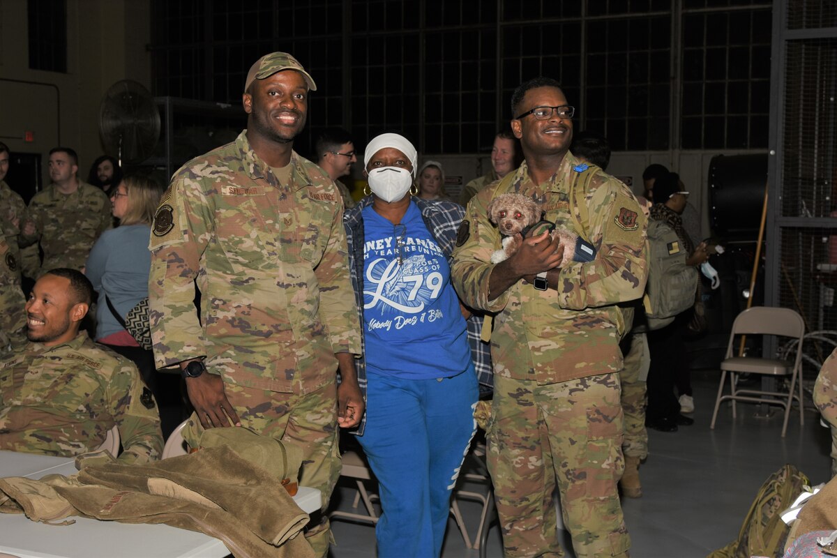 three people pose for a photo