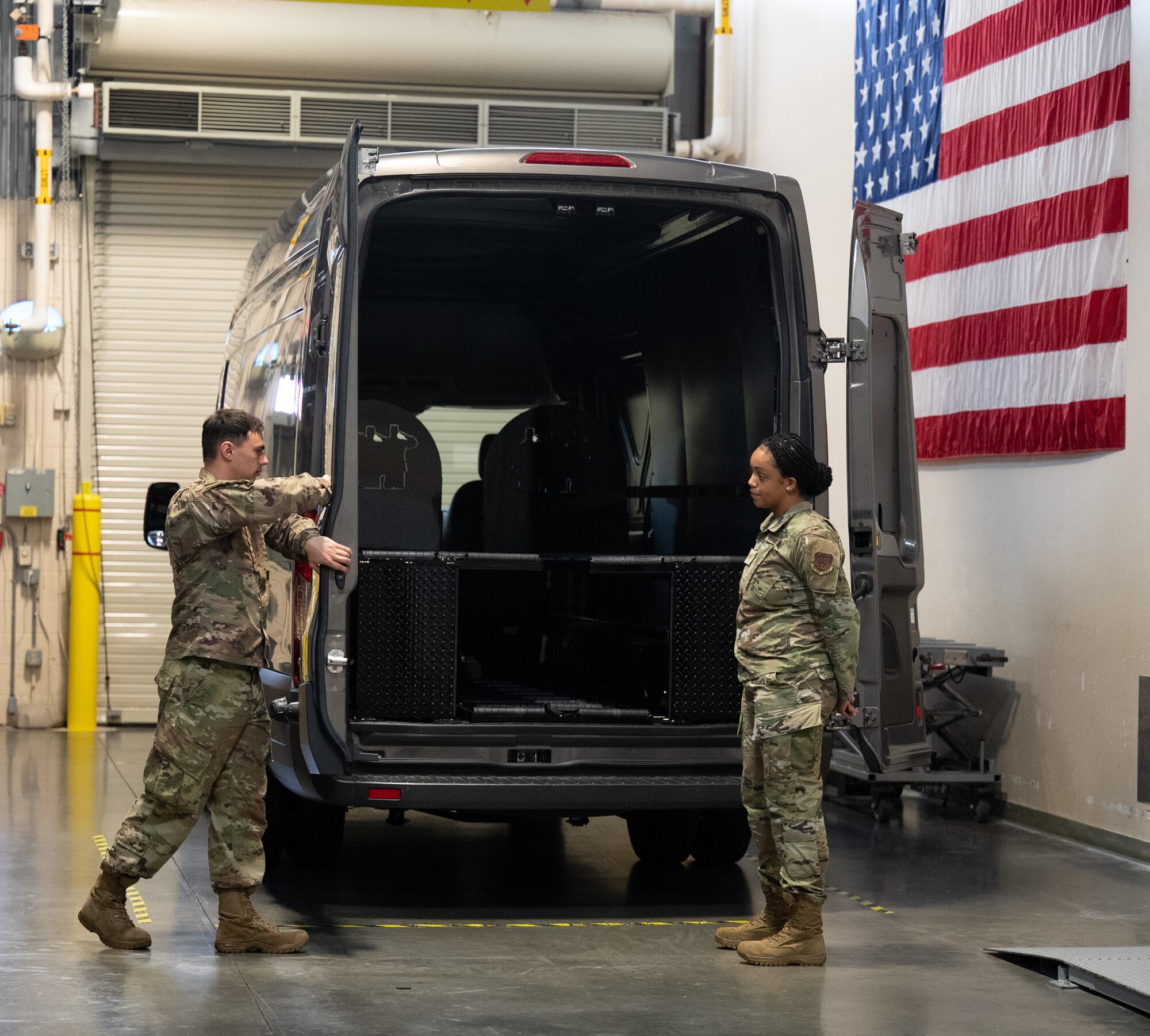 Staff Sgt. Zamiyah Warner, Air Force Mortuary Affairs Operations departures specialist, trains Staff Sgt. Joshua Goodburn on door closing procedures at Dover Air Force Base, Delaware, July 14, 2022. Warner is a reservist deployed to AFMAO from the 512th Memorial Affairs Squadron.  (U.S. Air Force photo by Jason Minto)