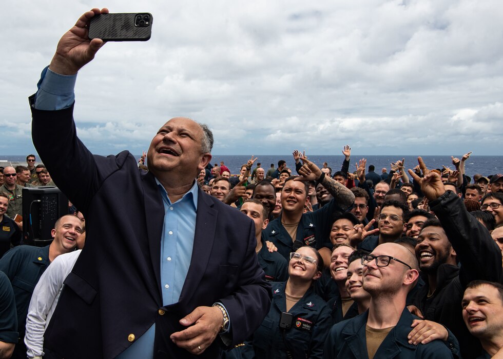 SECNAV Carlos Del Toro takes a photo with Sailors aboard USS Essex (LHD 2) during RIMPAC 2022.