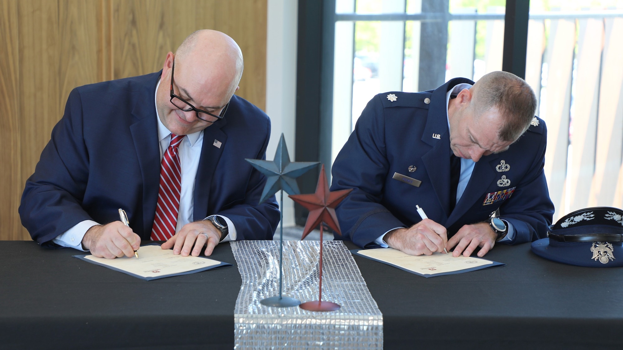 Left, Davis Technical College president Darrin Brush and Lt. Col. Adam Pierce, 367th Training Support Squadron commander sign into effect the educational and professional develop partnership agreement