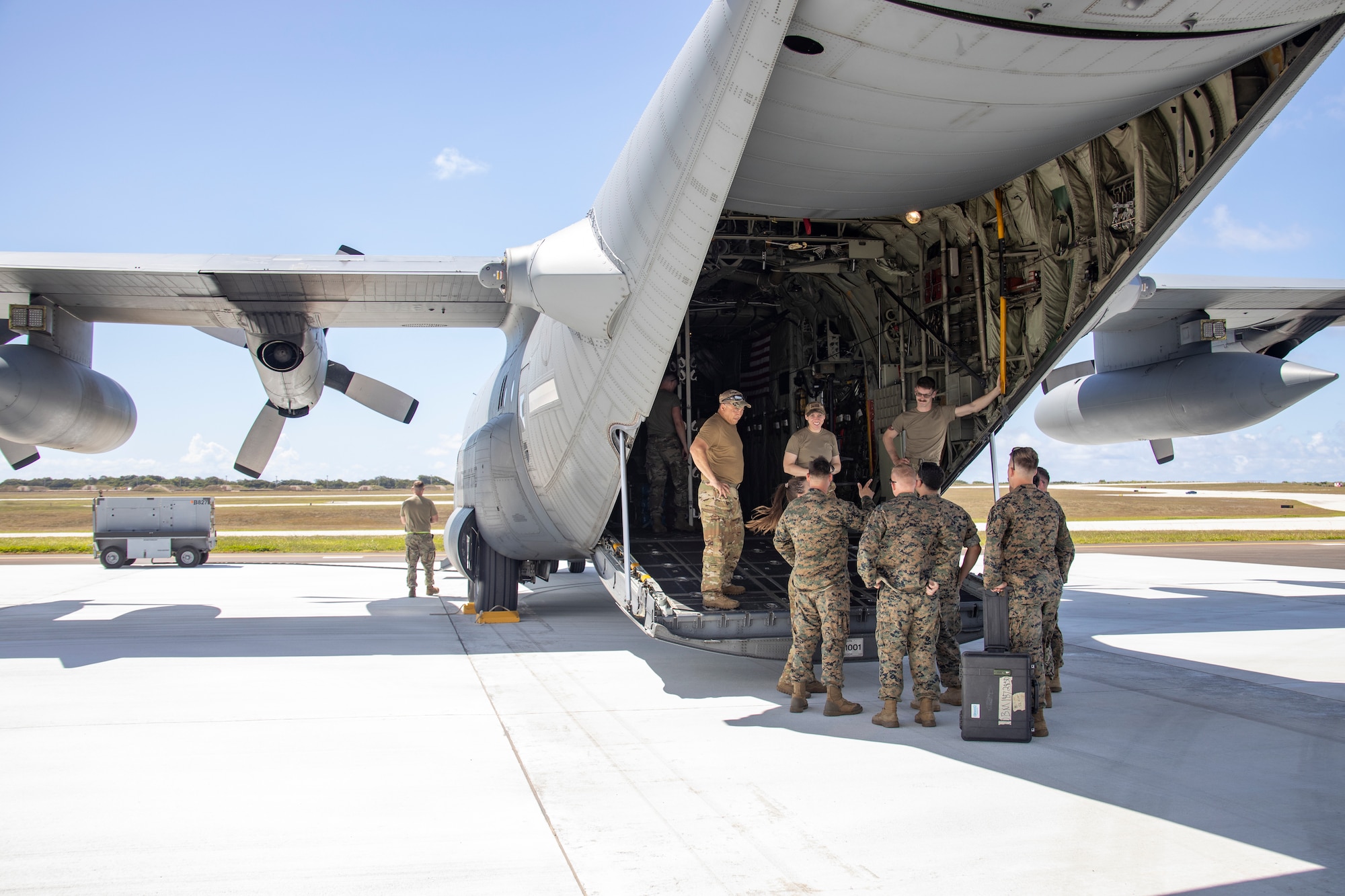 U.S. Marines with 5th Battalion, 11th Marine Regiment, 1st Marine Division and U.S. Air Force Airmen with Air National Guard, 133rd Airlift Wing, St. Paul, Minnesota, discuss loading procedures during a U.S. Marine Corps High-Mobility Artillery Rocket System onload in support of exercise Valiant Shield 2022 at Andersen Air Force Base, Guam, June 7, 2022.