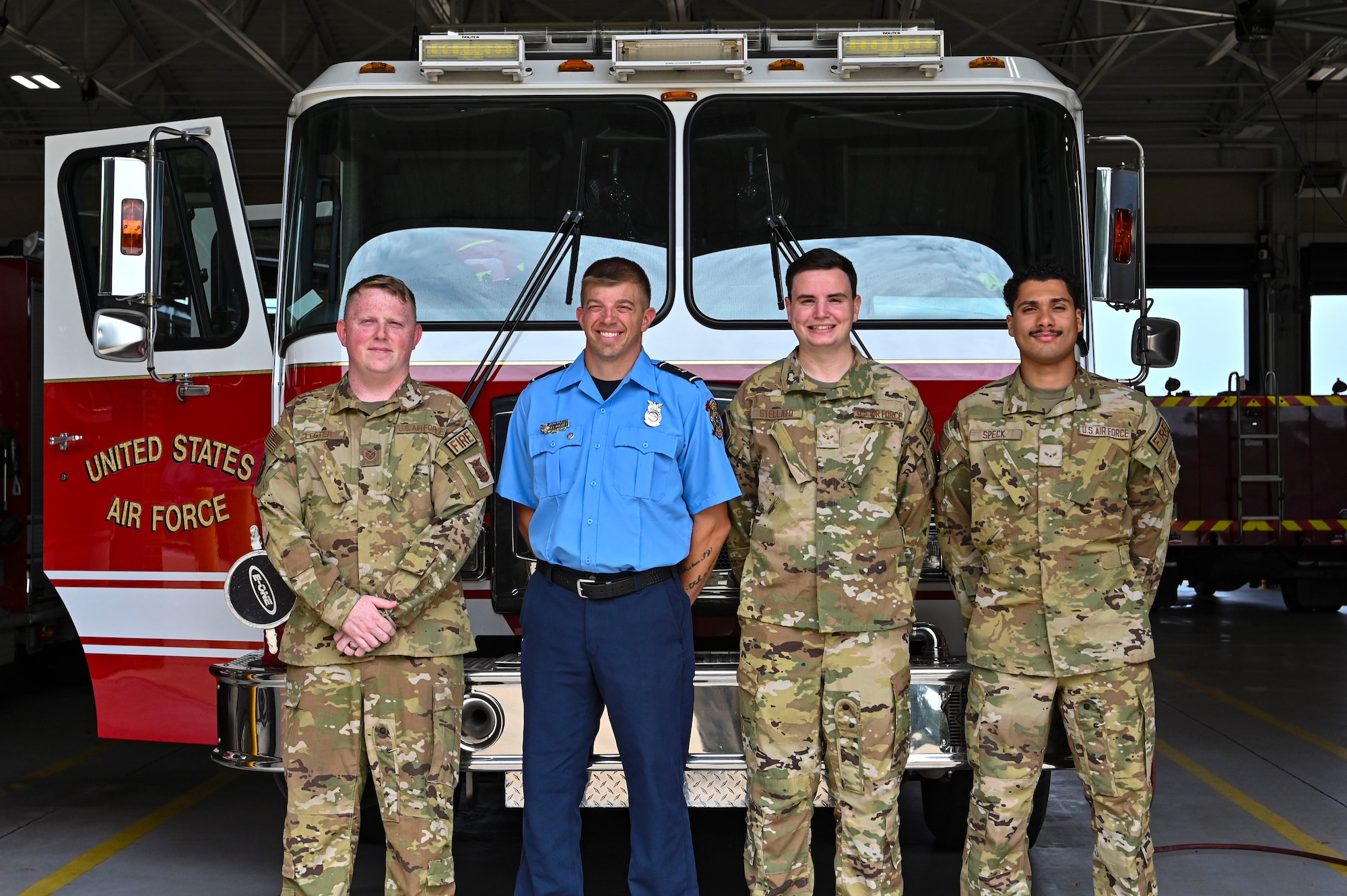Four firefighters from the 14th Civil Engineering Squadron pose in-front of Engine #7 July 18, 2022, at Columbus Air Force Base Miss. Firefighters at Columbus AFB are trained to drive and operate the engines as well as many other tasks besides firefighting. (U.S. Air Force photo by Airman 1st Class Jessica Blocher)