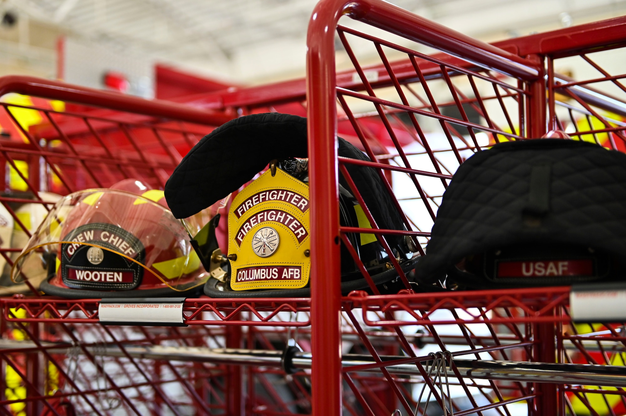 Helmets sit on a rack readily available for all the firefighters on shift, July 18, 2022, at Columbus Air Force Base Miss. It is difficult to spot anyone in the midst of smoke, so the bright red and yellow colors on the firefighter’s helmets assist in visibility when needed. (U.S. Air Force photo by Airman 1st Class Jessica Blocher)