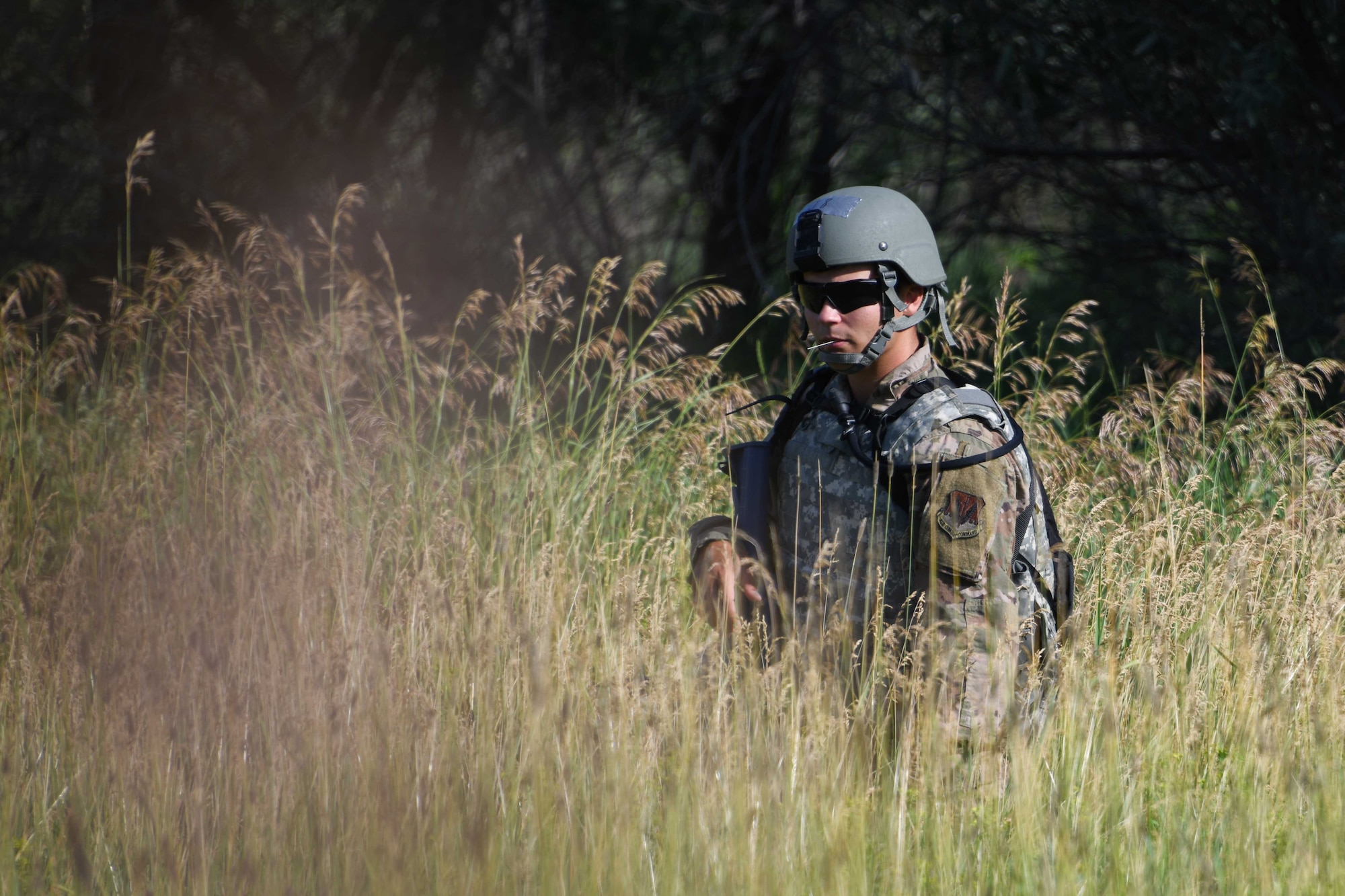 An Airman from the 319th Civil Engineer Squadron sits on watch during a Prime Base Engineer Emergency Force training on Grand Forks Air Force Base, North Dakota, July 14, 2022. The goal of Prime BEEF training is to create and maintain civil engineer forces capable of completing multiple objectives at any time. (U.S. Air Force photo by Senior Airman Ashley Richards)