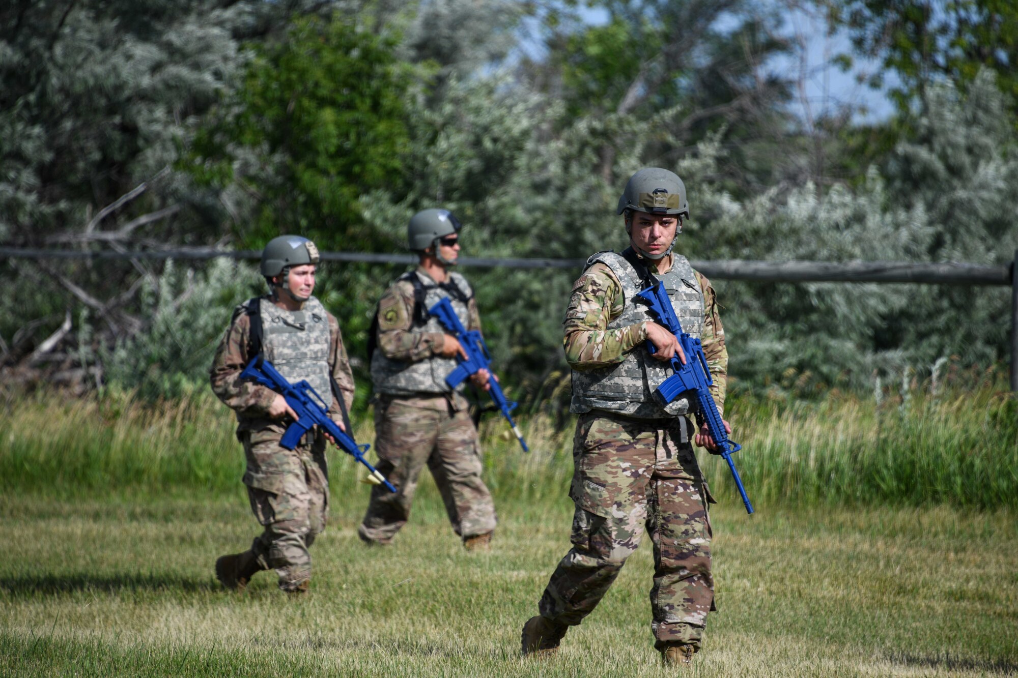 Airmen from the 319th Civil Engineer Squadron practice troop movements during a Prime Base Engineer Emergency Force training on Grand Forks Air Force Base, North Dakota, July 14, 2022. The Prime BEEF training allowed Airmen to exercise and conduct operations down range, which included hands-on training such as land navigation, troop movement, and tactical combat casualty care. (U.S. Air Force photo by Senior Airman Ashley Richards)