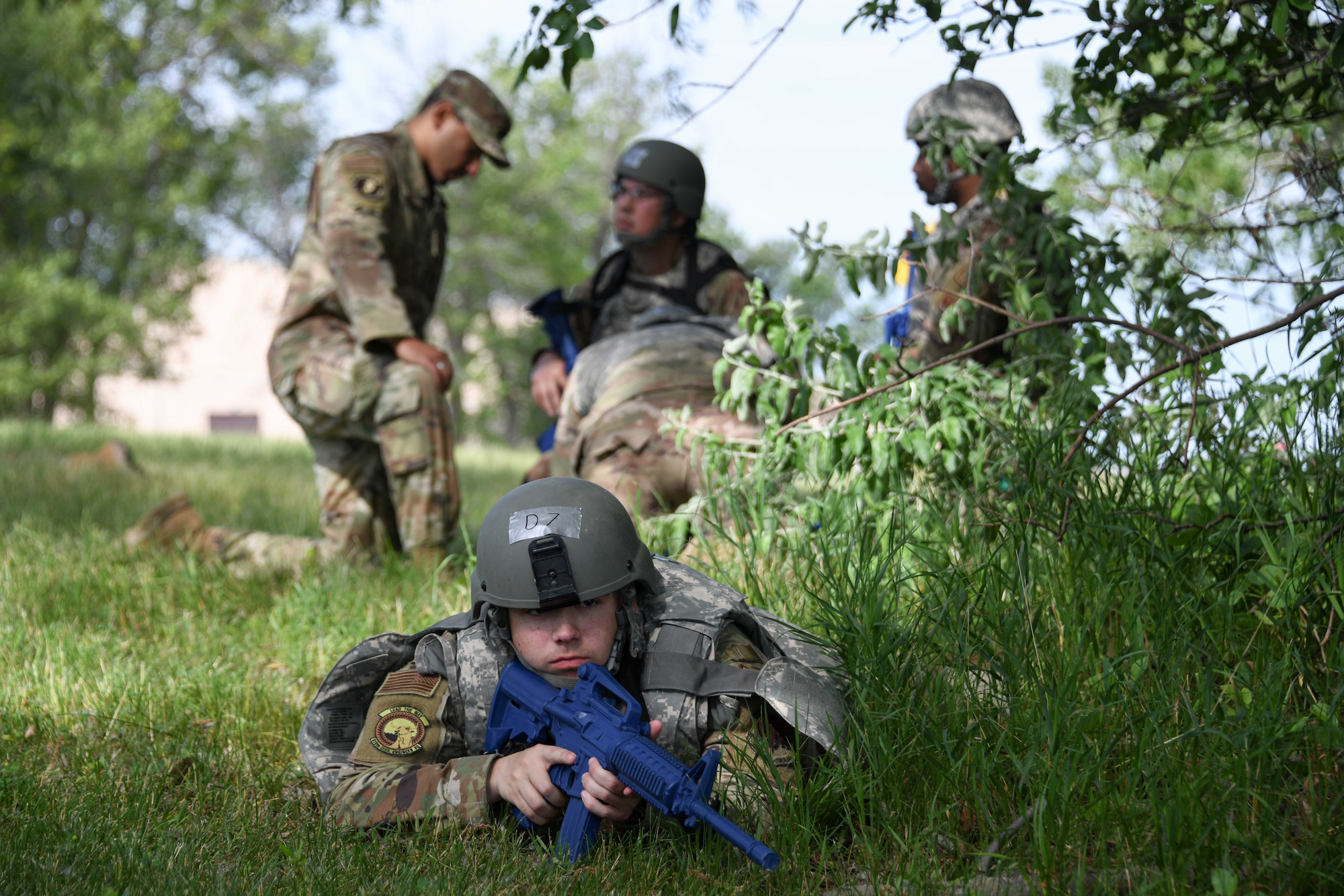 An Airman from the 319th Civil Engineer Squadron lays in the prone position during a Prime Base Engineer Emergency Force training on Grand Forks Air Force Base, North Dakota, July 14, 2022. The goal of Prime BEEF training is to create and maintain civil engineer forces capable of completing multiple objectives at any time. (U.S. Air Force photo by Senior Airman Ashley Richards)