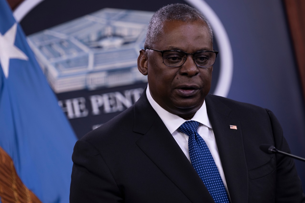 Secretary of Defense Lloyd J. Austin III speaks at a microphone.
