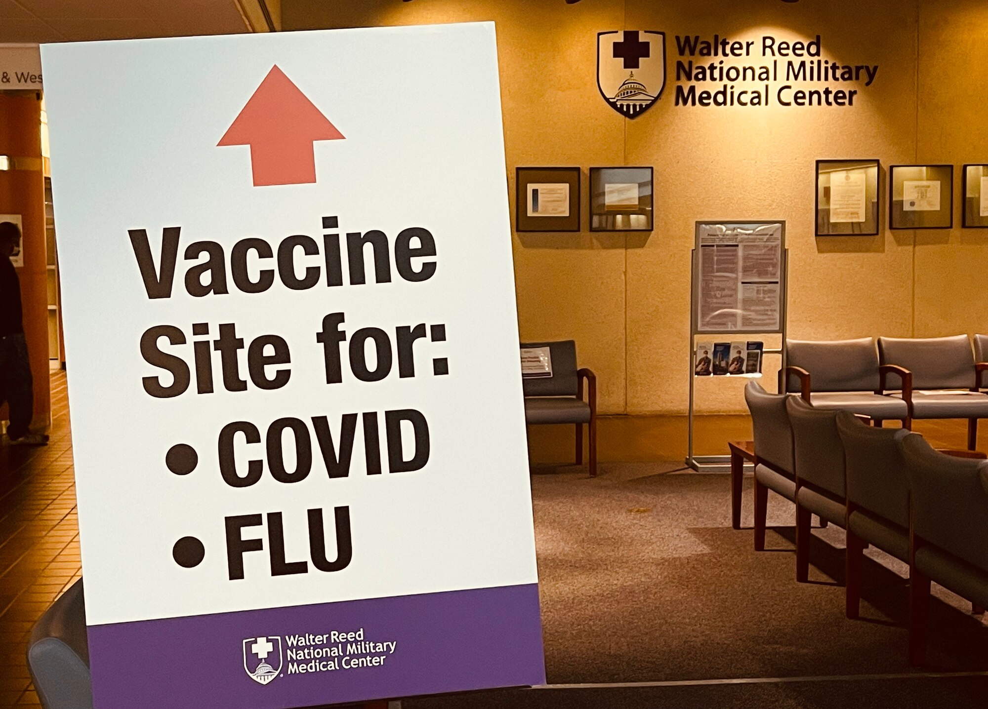 COVID-19 vaccination sign stands in Walter Reed National Military Medical Center, Bethesda, Maryland, Dec. 21, 2021. The sign reminds patients of areas to get their COVID-19 vaccine in the hospital.