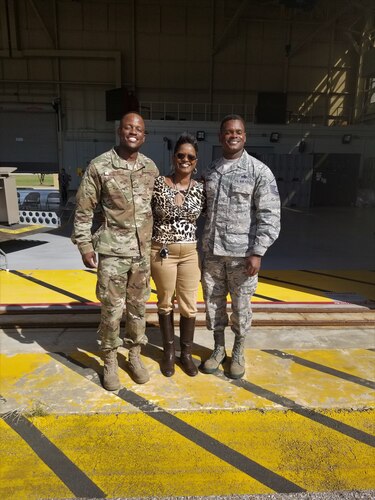 three people pose for a photo
