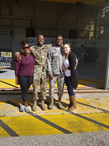 four people pose for a photo