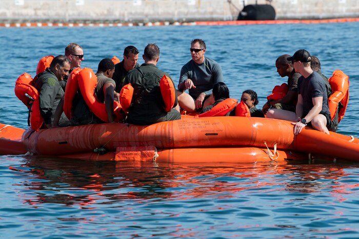 Reserve Citizen Airmen with the 514th Air Mobility Wing participate in a water survival training course at Naval Air Station Key West, Fla. on June 9, 2022. Airmen with the 514 AMW took advantage of a training block organized in Key West to complete various training requirements in a condensed timeframe. Training opportunities included M9 Barreta qualifications, water survival qualification, a SERE refresher course, tactical combat casualty care, and other required training.