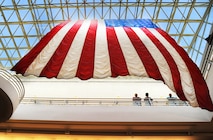 A giant flag flows gently above the 5th Medical Group facility at Minot Air Force Base
