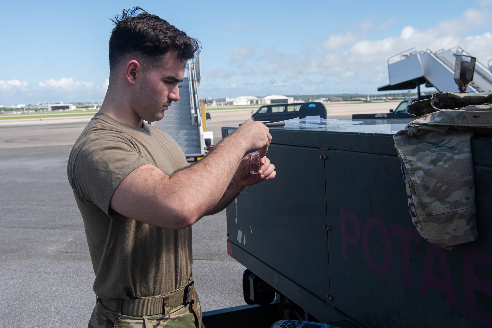 An Airman conducts a water sample chlorine test.