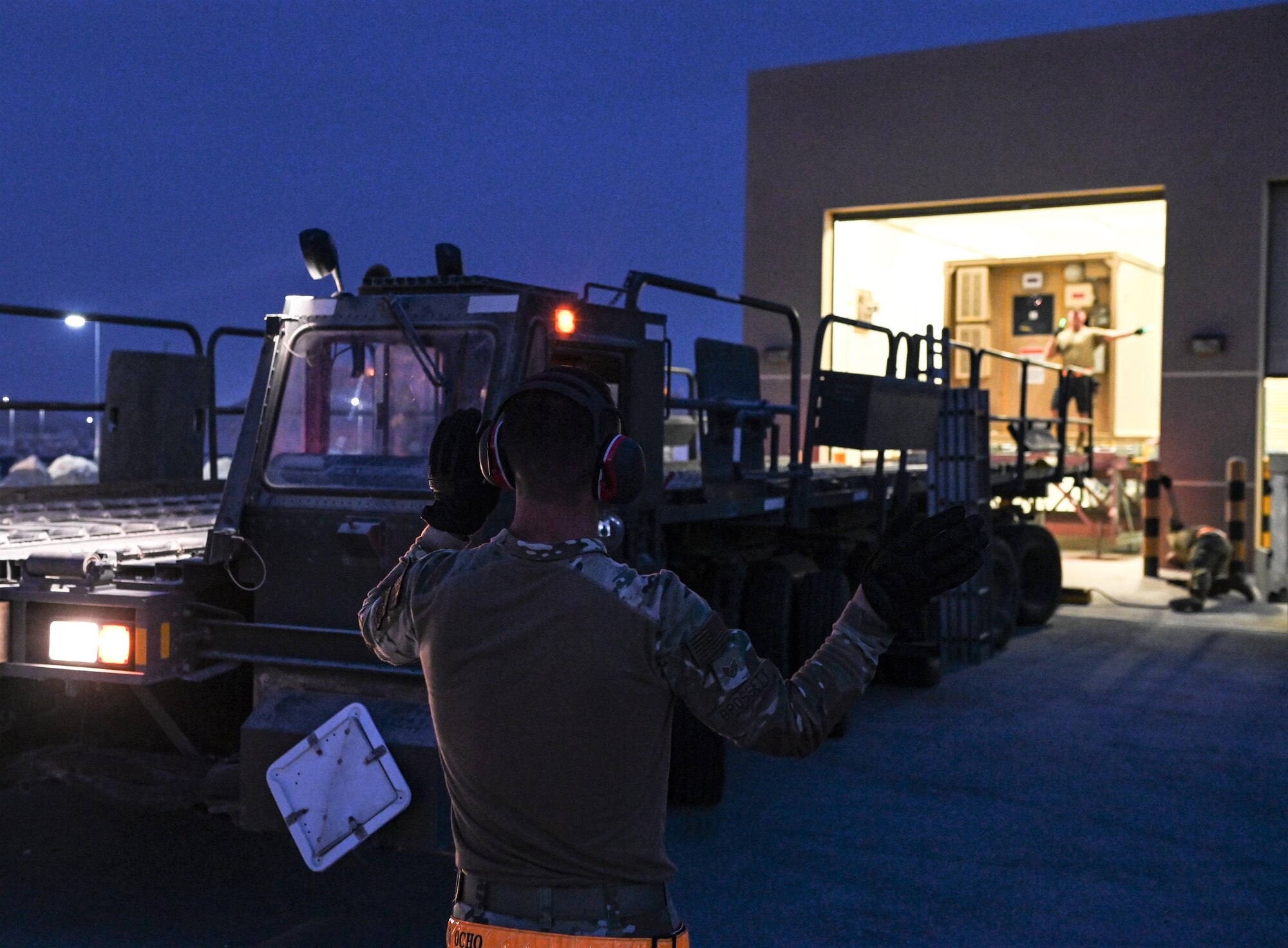Airmen with the 379th Logistics Readiness Squadron prepare to load negative pressurized container on to a trailer during an exercise July 11, 2022 at Al Udeid Airbase, Qatar. Practicing precise moment of mission essential equipment keeps airmen prepared for emergency situations. (U.S. Air National Guard photo by Tech. Sgt. Michael J. Kelly)