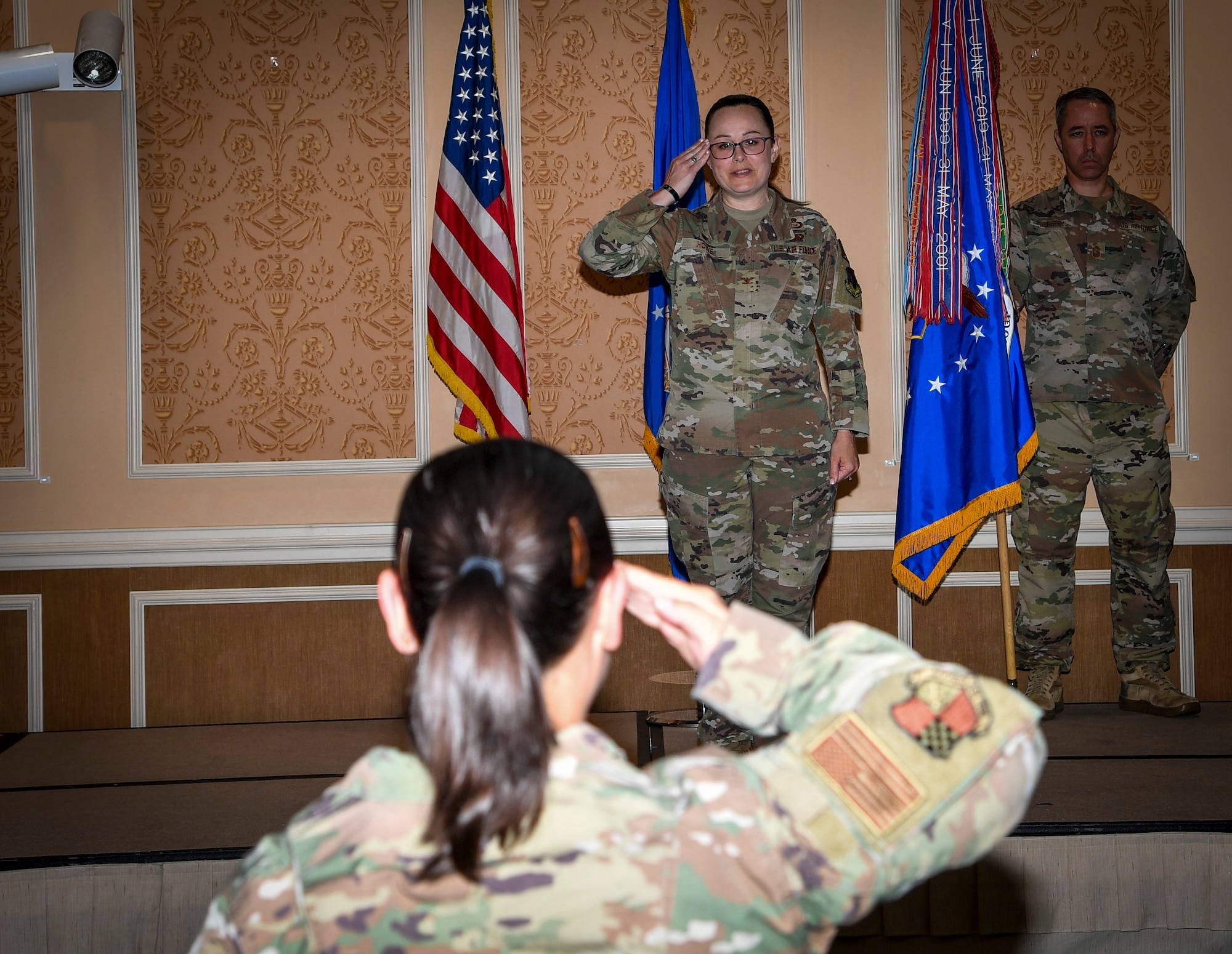 Photo of two individuals saluting each other.