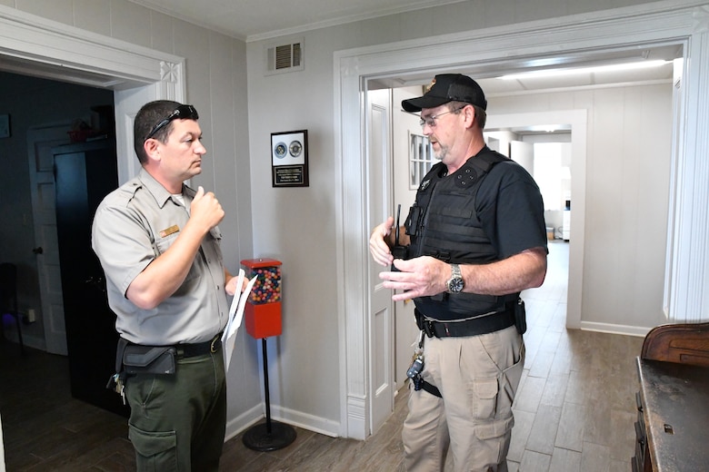 Josh Davis, Chief Ranger at the Walter F. George Resource Office, left, speaks with a Clay County Deputy at the Clay County Sheriff’s Office in Fort Gaines, Georgia, on July 6, 2022. Davis and the deputy were reviewing the holiday celebration at Walter F. George over the July 4 weekend.