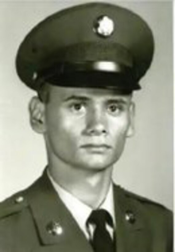 A man in a dress cap poses for a photo.