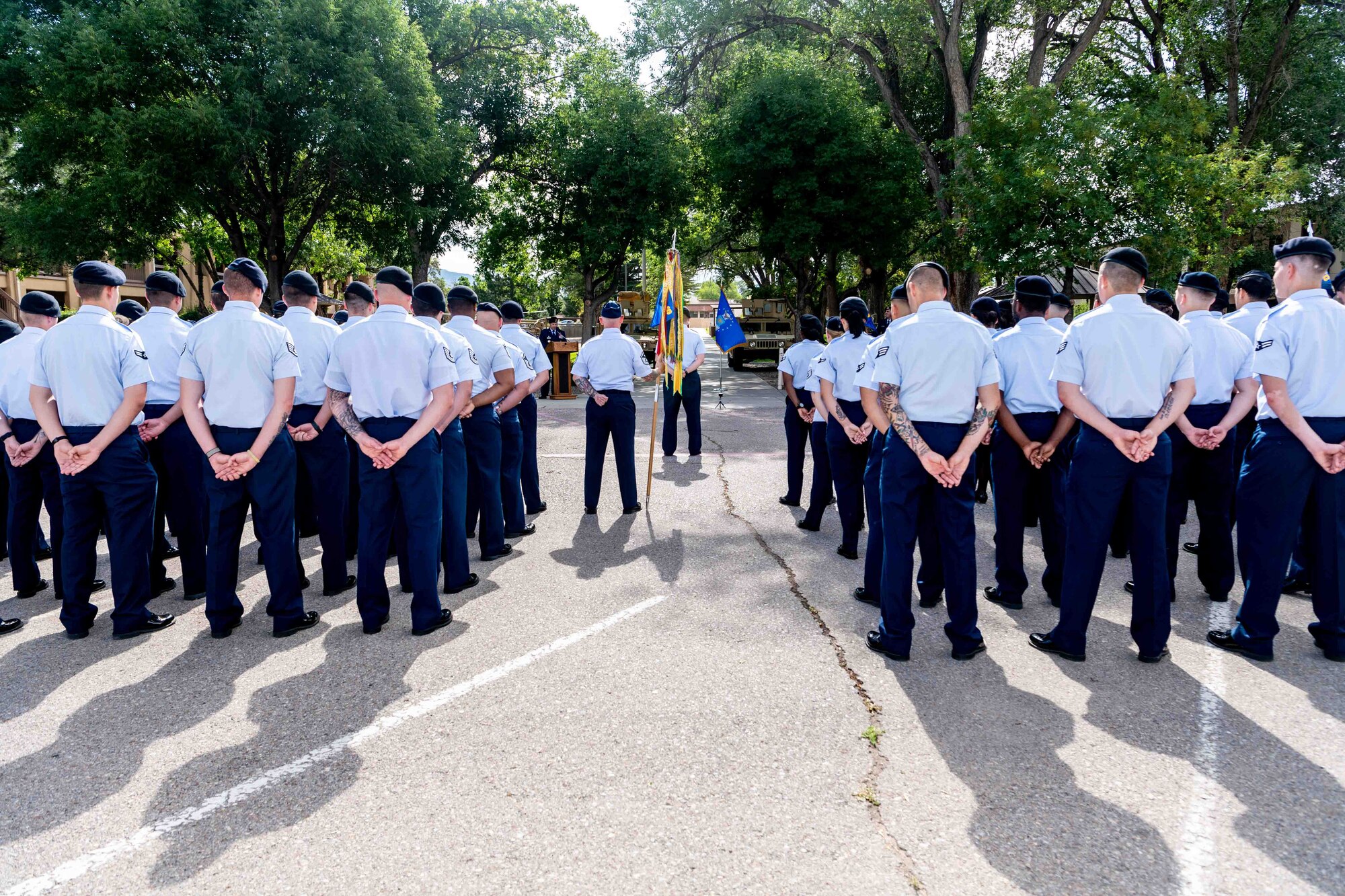 A group of Airmen stand at parade rest.