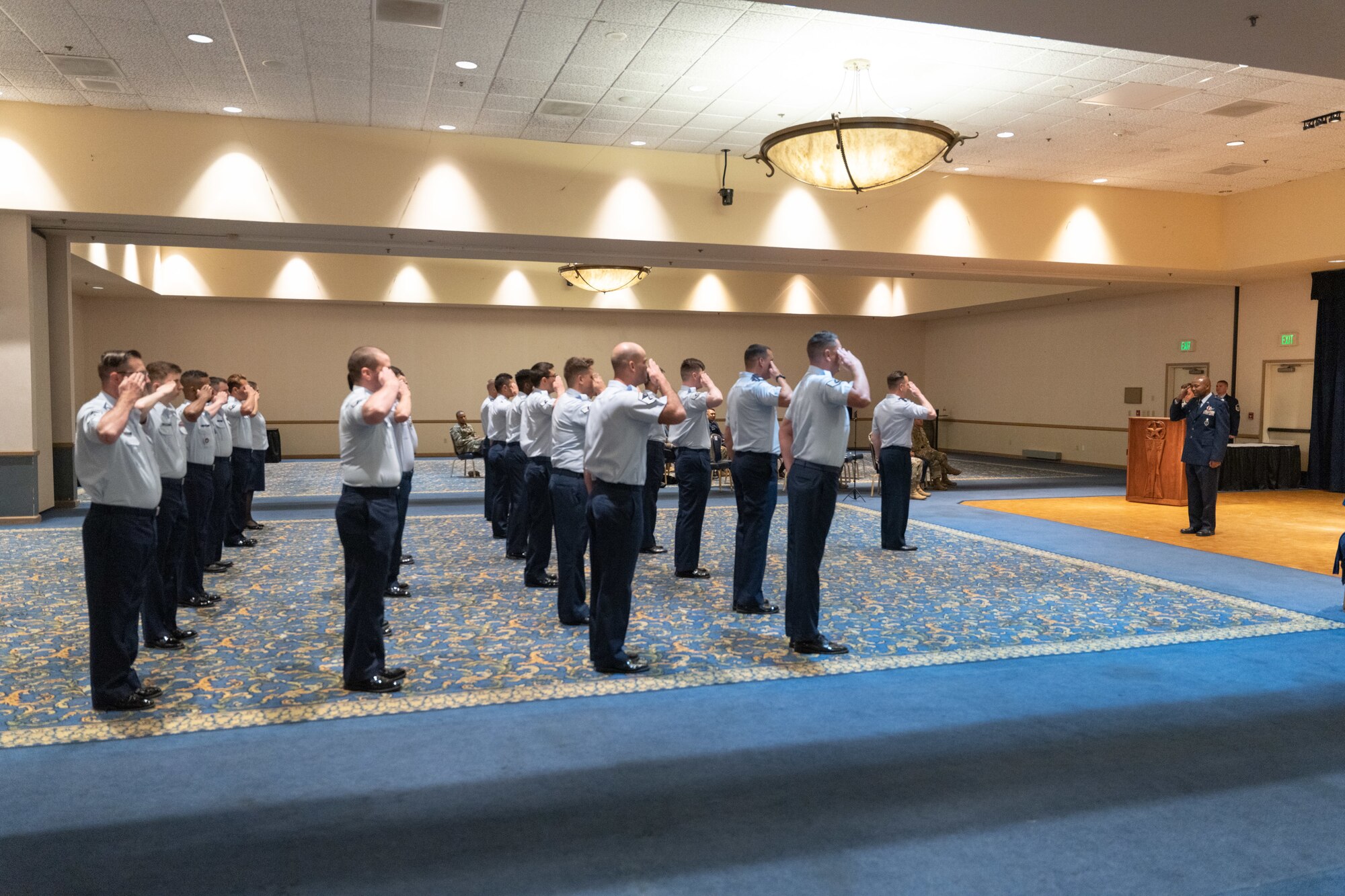 Airmen render salute to officer.