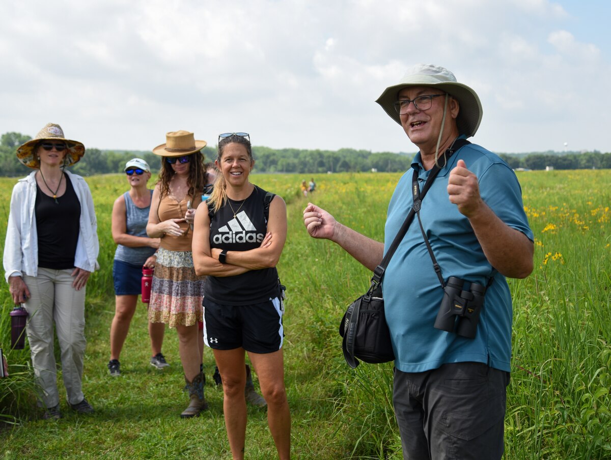 Dave Nolin, retired director of Five Rivers MetroParks, gives an informative walking tour to more than a dozen visitors to Huffman Prairie, which features over 300 species of wildflowers, Wright-Patterson Air Force Base, Ohio, July 20, 2022. Nolin has been coming to Huffman Prairie since 1985 and says it's his favorite nature park in the Dayton area.