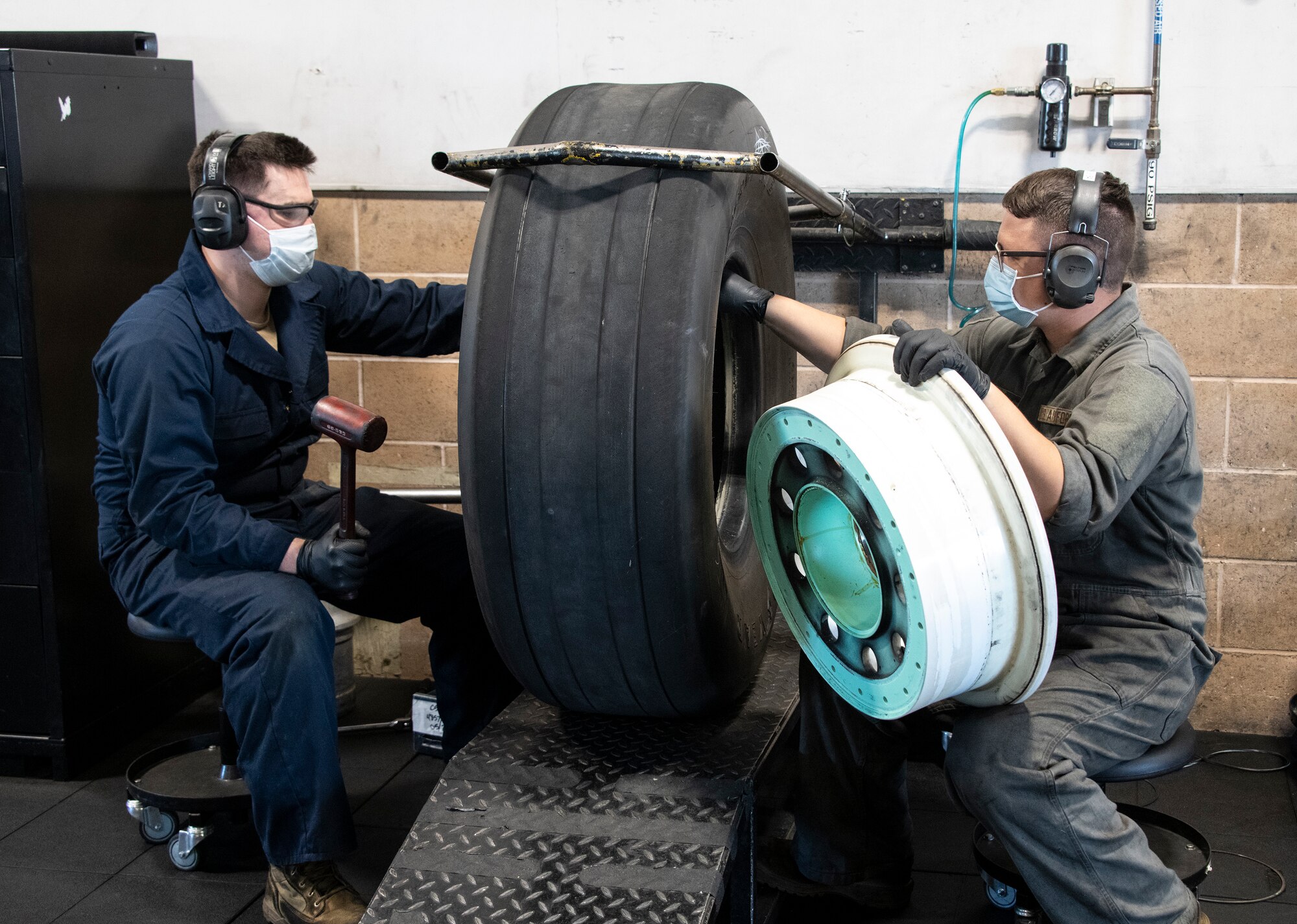 Airman fixing tires