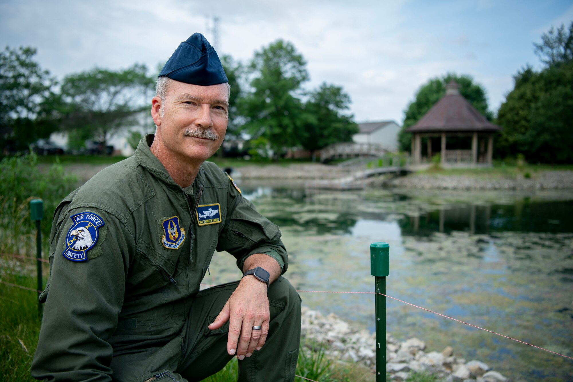 Master Sgt. Kenneth Knight, 434th Air Refueling Wing flight safety NCO, poses near the string fence surrounding the pond near Civil Engineering, June 23, 2022, at Grissom Air Reserve Base, Indiana. The string fence deters Canadian Geese from choosing the pond as their nesting ground. (U.S. Air Force photo by Staff Sgt. Alexa Culbert)