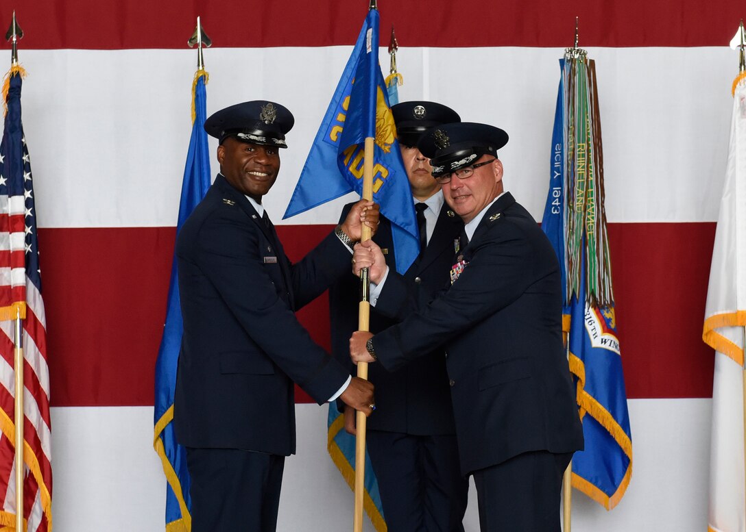 Col. Robert A. Corby, right, accepts command of the 316th Medical Group from Col. Todd Randolph, 316th Wing and Joint Base Andrews installation commander, during a change of command ceremony at Joint Base Andrews, Md., July 21, 2022. Chief Master Sgt. William Schumacher, 316th MDG senior enlisted leader, center, looks on.